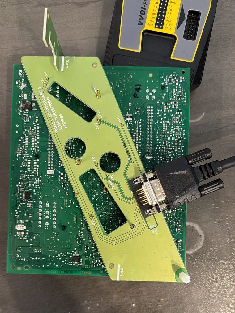 An adapter board seated on a vehicle control module