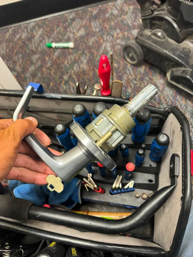 A commercial lever lock held above an open tool bag