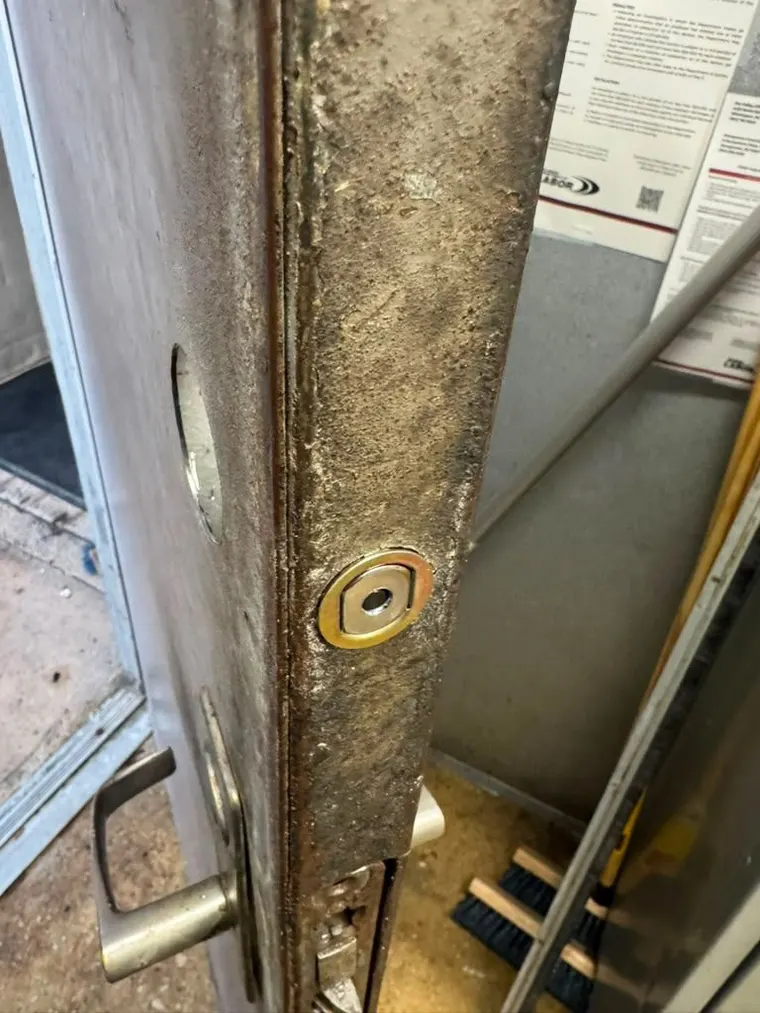 A commercial door frame repaired around the lock after damage