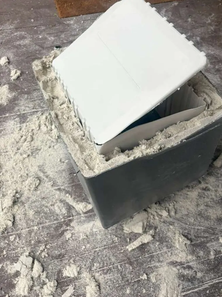 A floor safe set into the concrete at a home entrance