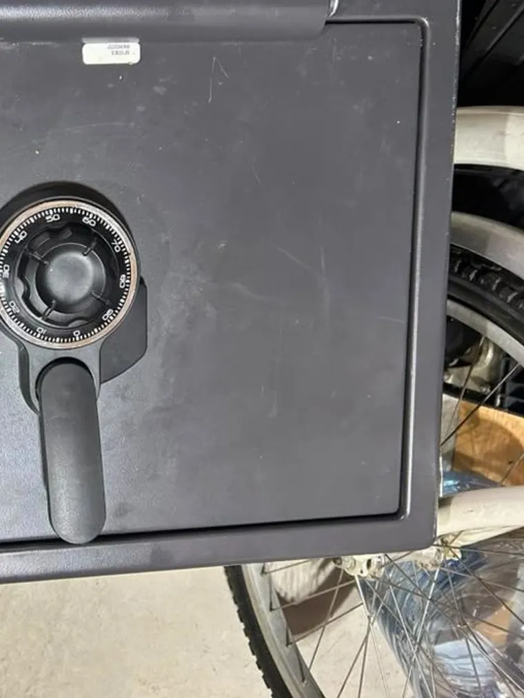 A combination safe standing in a garage after being reset